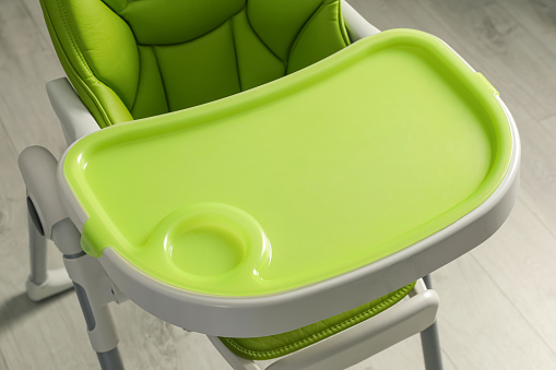 Green baby high chair indoors, above view