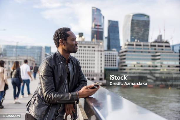 Mature Black Male Tourist Enjoying A Beautiful Cityscape From A Bridge In London Stock Photo - Download Image Now