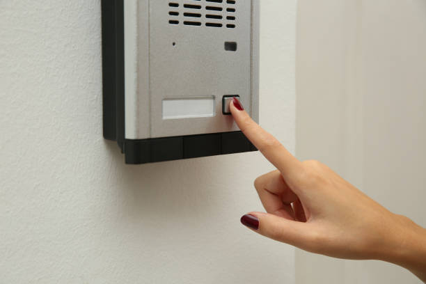 istock African-American woman pushing intercom button in entryway, closeup 1423567688