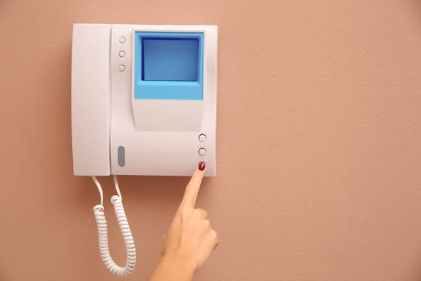 istock African-American woman pressing button on intercom panel indoors, closeup. Space for text 1423568217