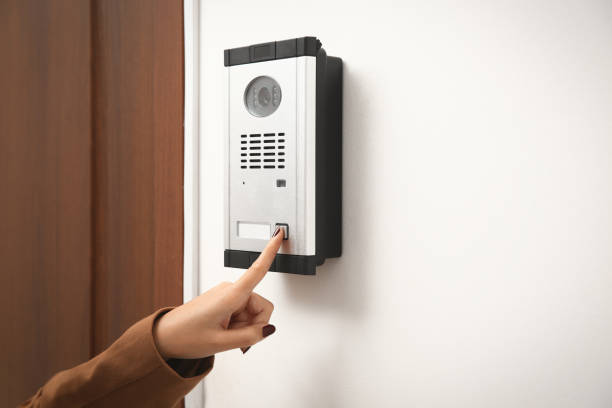 istock African-American woman ringing intercom with camera in entryway, closeup 1423568239