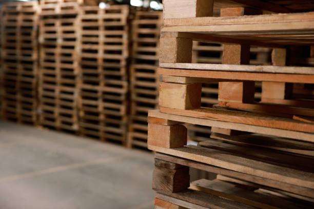istock Many empty wooden pallets stacked in warehouse, closeup. Space for text 1423568370