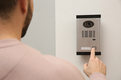 Intercom Ringing Phone Man Ringing Intercom With Camera In Entryway Stock Photo - Download ...