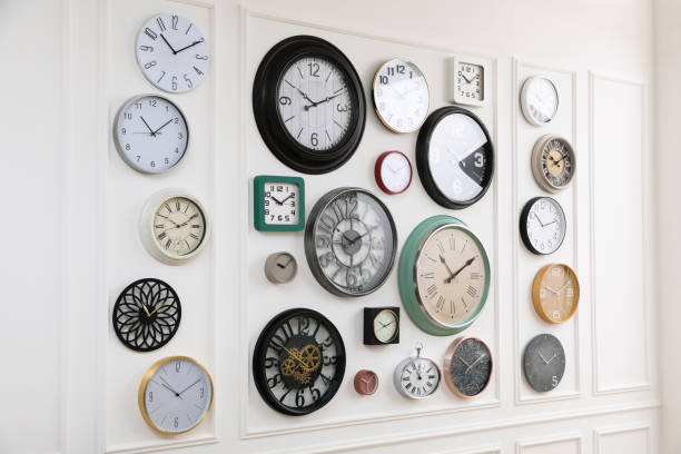 istock Collection of different clocks hanging on white wall 1423571303