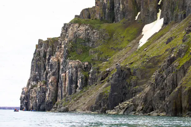 Photo of Bizarre rock formation. Alkefjellet, one of the largest and most spectacular bird cliffs on Svalbard.