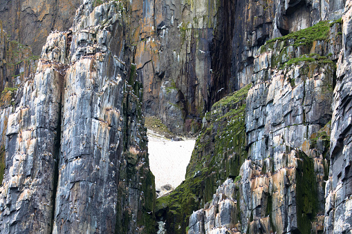 Alkefjellet cliff is the most famous cliff in Spitsbergen archipelago. It is a bird cliff overlooking Hinlopen Fjord.\nBizarre rock formation. Spitsbergen, Norway.