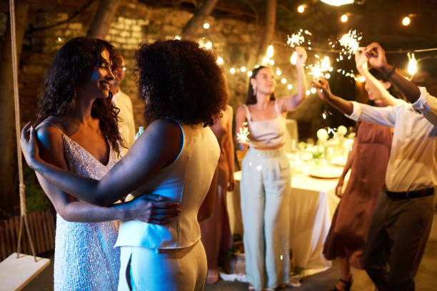 istock Two young amorous intercultural women in white wedding attire dancing 1423572960