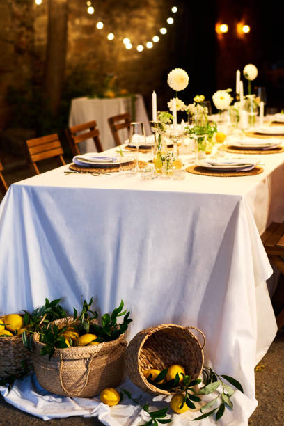 istock Front view of served festive table and baskets with lemons on the floor 1423572961