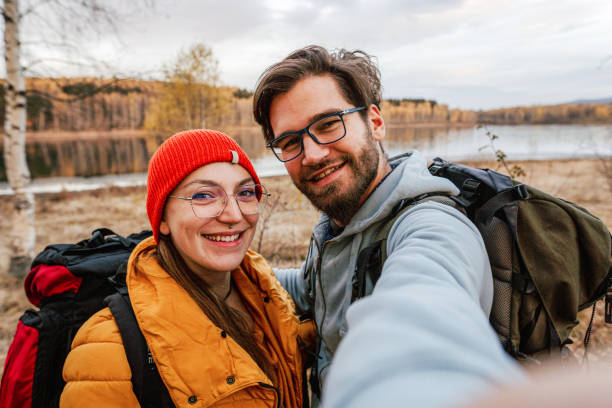 istock Happy young couple takes a selfie while hiking 1423573117