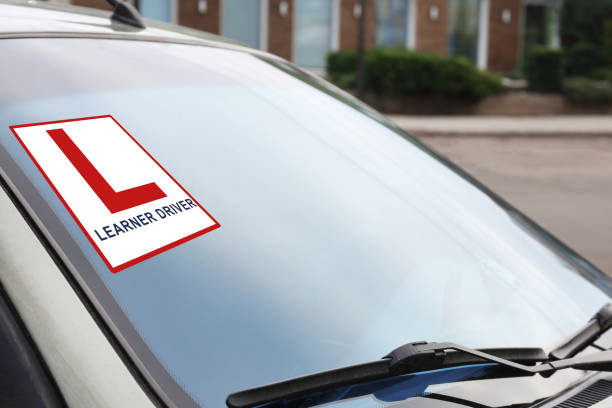 istock Modern car with L-plate sign on window, closeup 1423573361