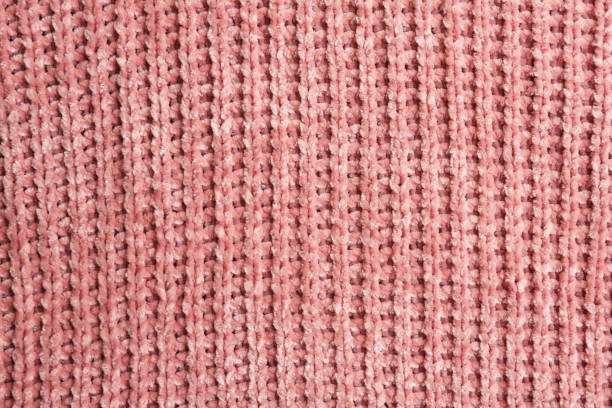 istock Beautiful pink knitted fabric as background, top view 1423573422