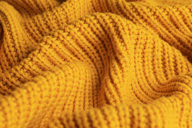 istock Beautiful orange knitted fabric as background, closeup 1423573584