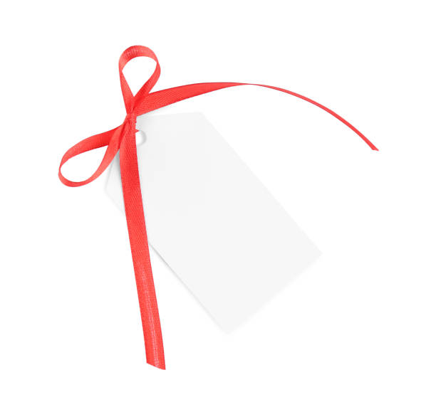 istock Blank gift tag with red satin ribbon on white background, top view 1423573650
