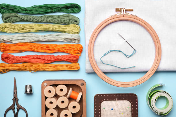 istock Flat lay composition with embroidery accessories on light blue background 1423573823