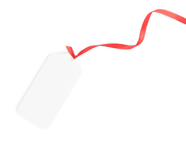 istock Blank gift tag with red satin ribbon on white background, top view 1423573850