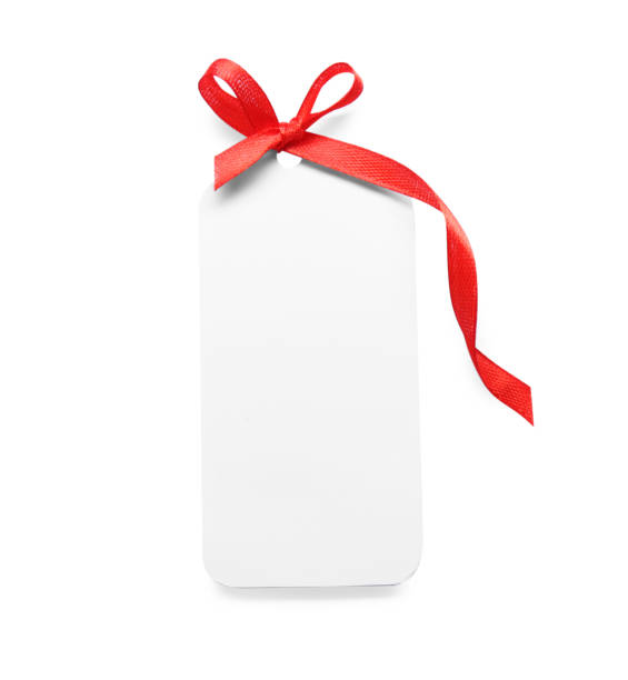 istock Blank gift tag with red satin ribbon on white background, top view 1423573906