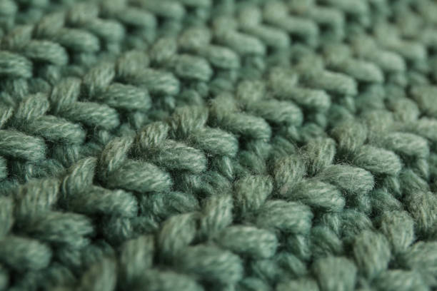 istock Beautiful pale green knitted fabric as background, closeup 1423575979