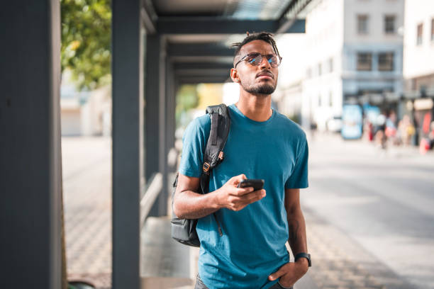 istock Cool Young African American Male Using A Smart Phone While Commuting In The City 1423576139
