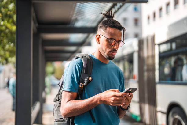 istock Cool Young African American Male Using A Smart Phone While Commuting In The City 1423576142