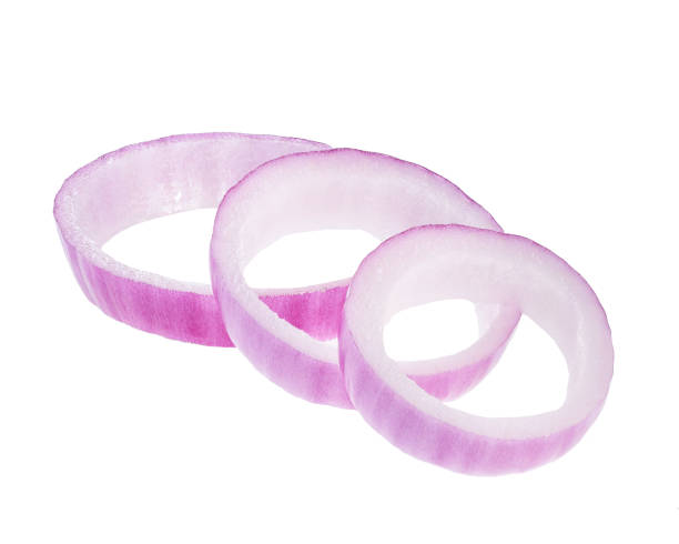istock Sliced red onion rings isolated on white background. 1423577500