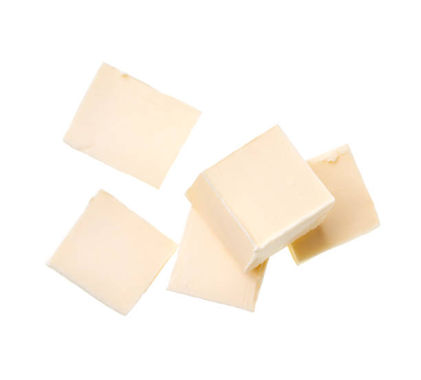 istock Pieces of butter isolated on white background, top view. 1423579600