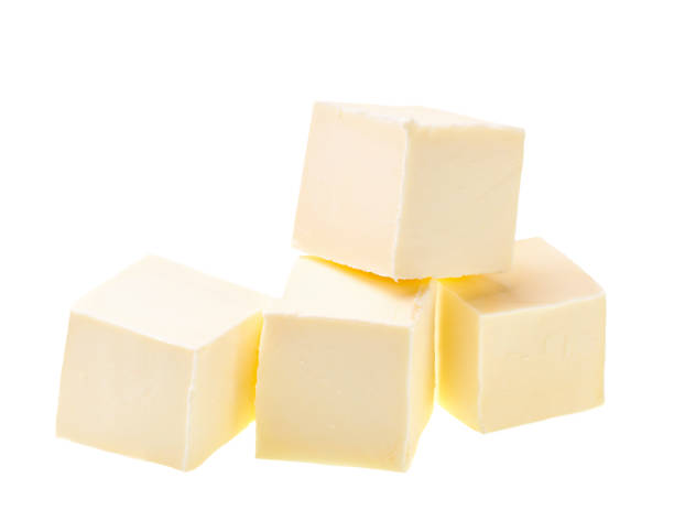 istock Pieces of butter isolated on white background. 1423579605