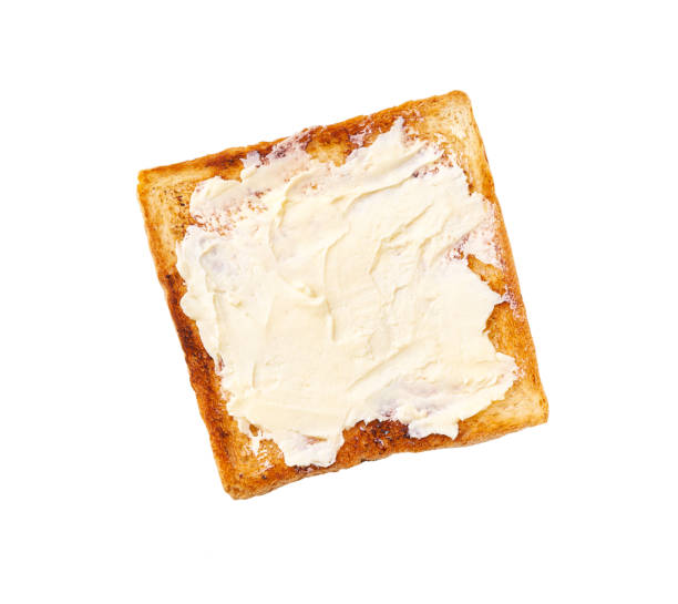 istock toasted bread and butter isolated on white background, top view 1423579657