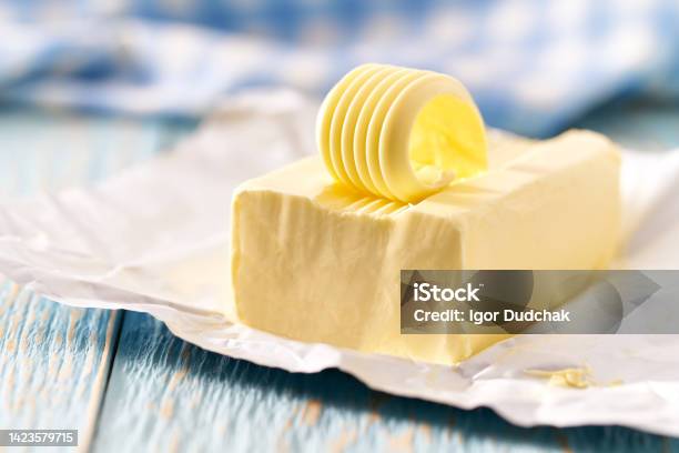 Whole Block Butter On A Blue Wooden Table Selective Focus Stock Photo - Download Image Now