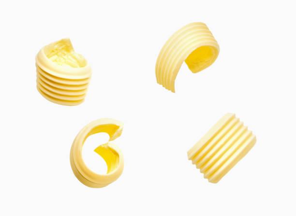 istock different butter curls or rolls isolated on white background. Top view. 1423579735