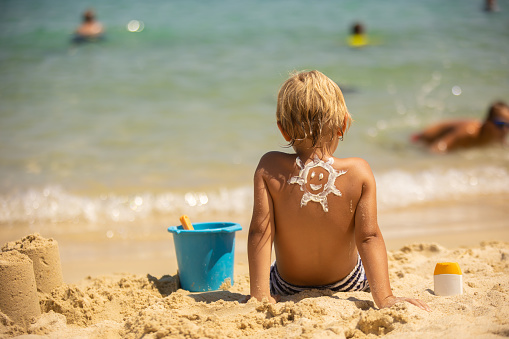 Shot of a man spending time with his family at the beach