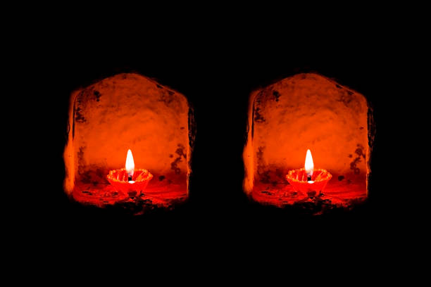 two traditional diya lamps lit during diwali celebration. happy diwali lit diya lamp on street at night or diwali diya or clay lamp on wall background. - nightshot imagens e fotografias de stock