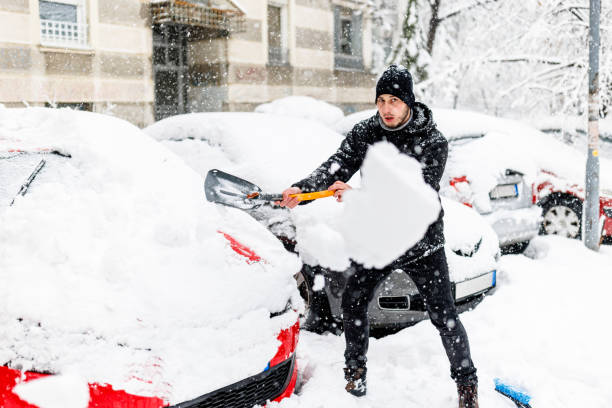 istock A Man has Snow Problems with a Car so he is Shoveling it. 1423580689