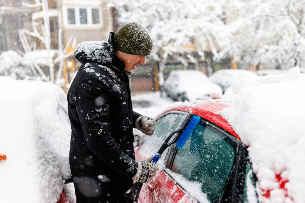 istock A Man is Cleaning a Snow From the Car with Brush. 1423581007