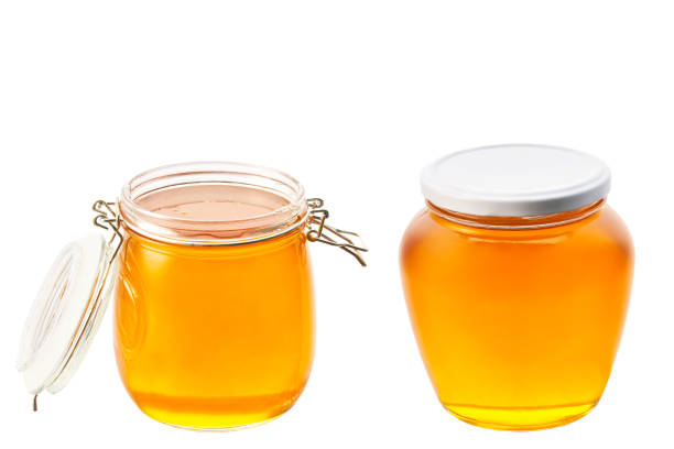 istock two large jars of honey isolated on white background. 1423583904