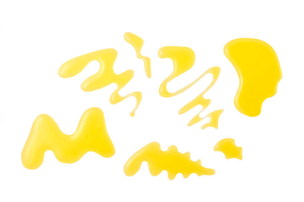 istock drops and splashes of honey isolated on white background. Top view. 1423583971