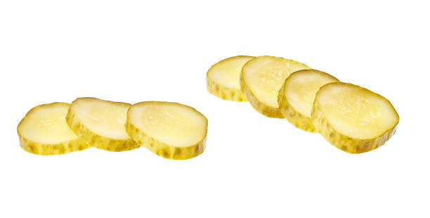 istock Sliced pickled cucumber isolated on white background . 1423584068