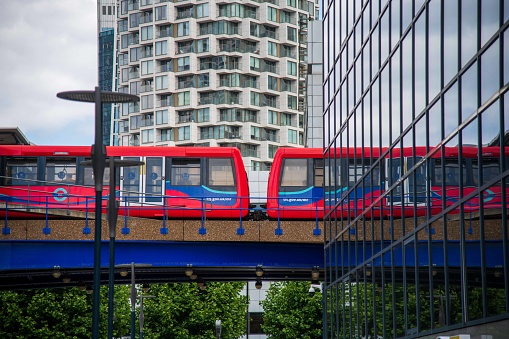 London, United Kingdom - June 13, 2022: DLR Reflection on Glass building in Canary Wharf
