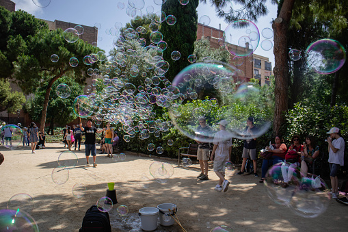 Children's street performer/entertainer blowing huge bubbles for tourists and children in Barcelona, Spain