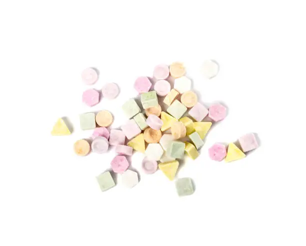 Tablet candies isolated. Compressed sugar powder confectionery, dextrose candy necklace parts, vitamin c tablets, lozenges on white background