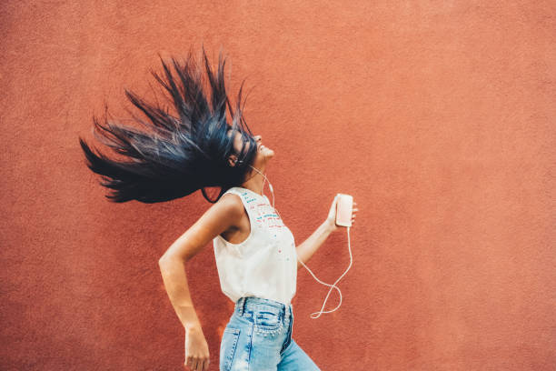 istock Woman dancing to the music 1423587252