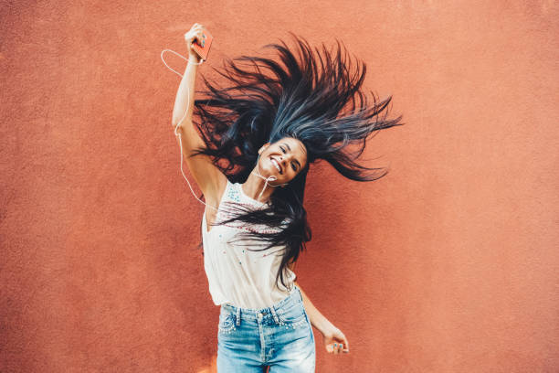 istock Woman dancing to the music 1423587307