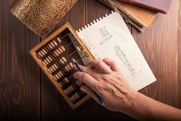 Vintage tone of women's hands doing accounting with old accounts . financial concept. Vintage tone of women's hands doing accounting with old accounts . financial concept abacus stock pictures, royalty-free photos & images