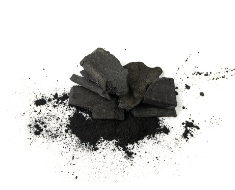 Activated carbon isolated. Active coal pile, absorbent charcoal closeup, graphite filter, absorb activated coal on white background