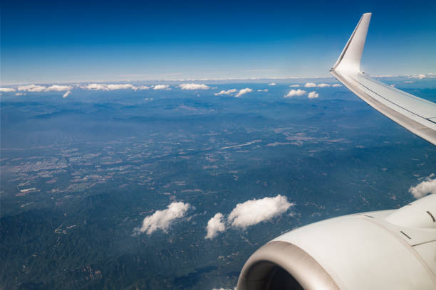 View out of airplane window at sky and nice clouds.