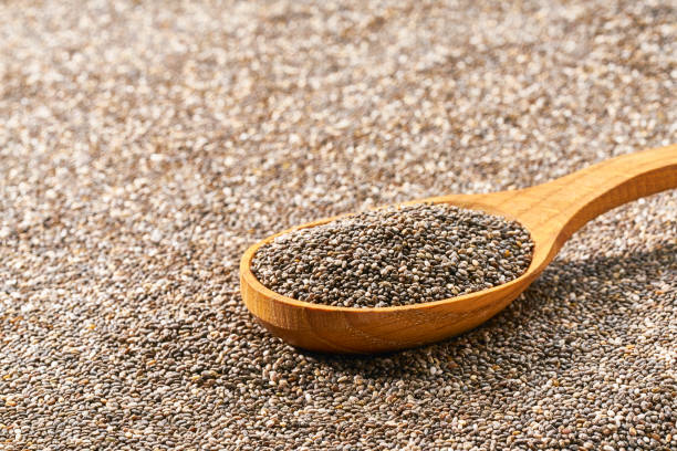 istock wooden spoon filled with chia seeds, selective focus. 1423592255