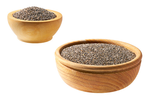 chia seeds in a wooden bowl with a spoon isolated on a white background.