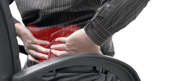 office worker sit on chair with back pain stock photo