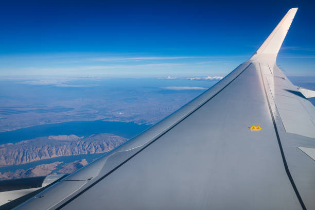 View out of airplane window at sky and nice clouds.