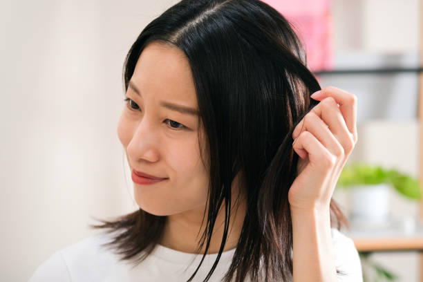 istock Woman checking hair 1423593551