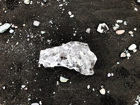 Piece of Ice on the Black Sand Diamond Beach Iceland Eystri-Fellsfjara at Jökulsárlón, Southern Iceland